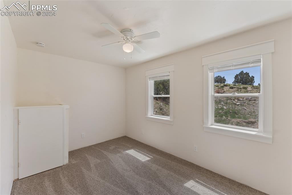 659 Turrell Trail Penrose, CO 81240 - Photo 12 of 19 a view of an empty room with a window