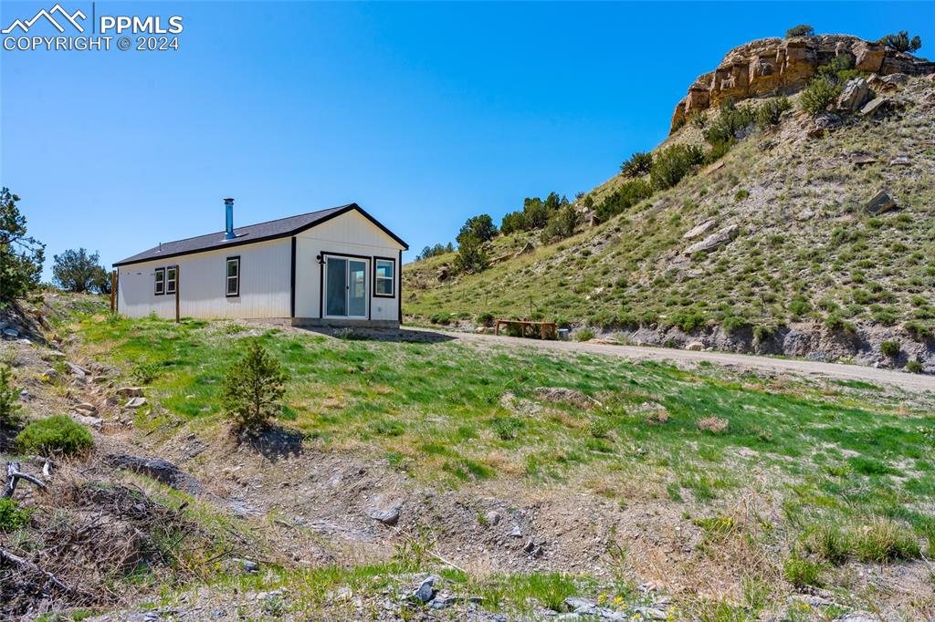 659 Turrell Trail Penrose, CO 81240 - Photo 17 of 19 a view of a house with a yard