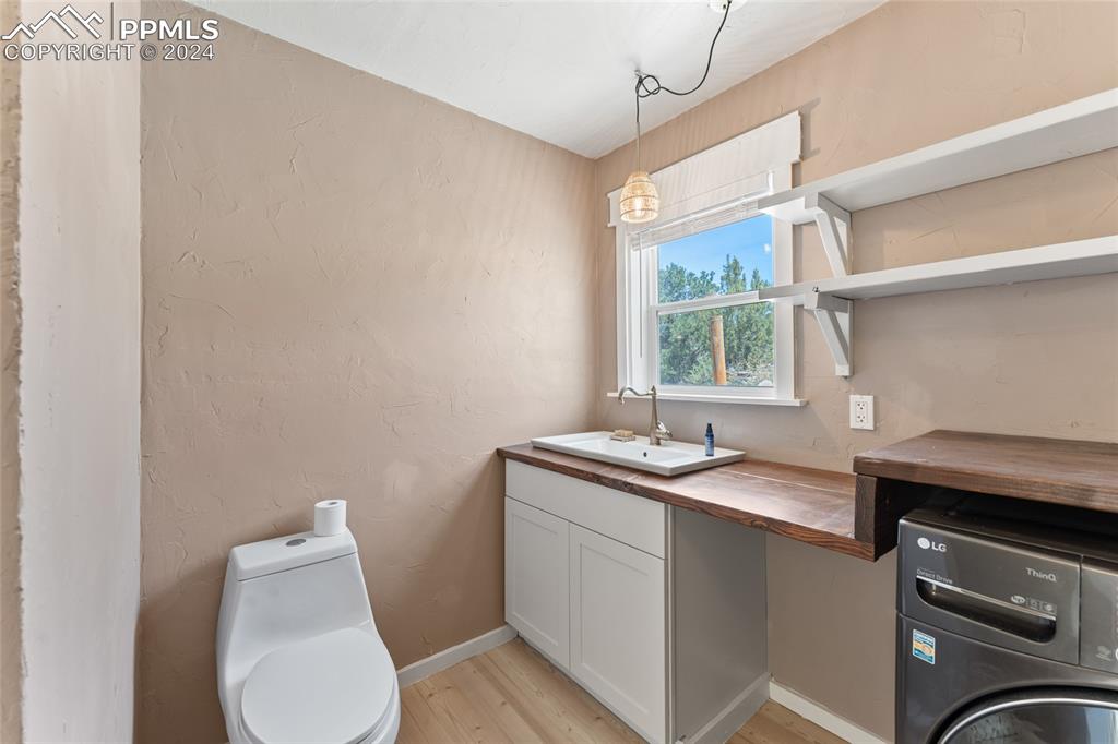 659 Turrell Trail Penrose, CO 81240 - Photo 10 of 19 a bathroom with a granite countertop toilet sink and mirror