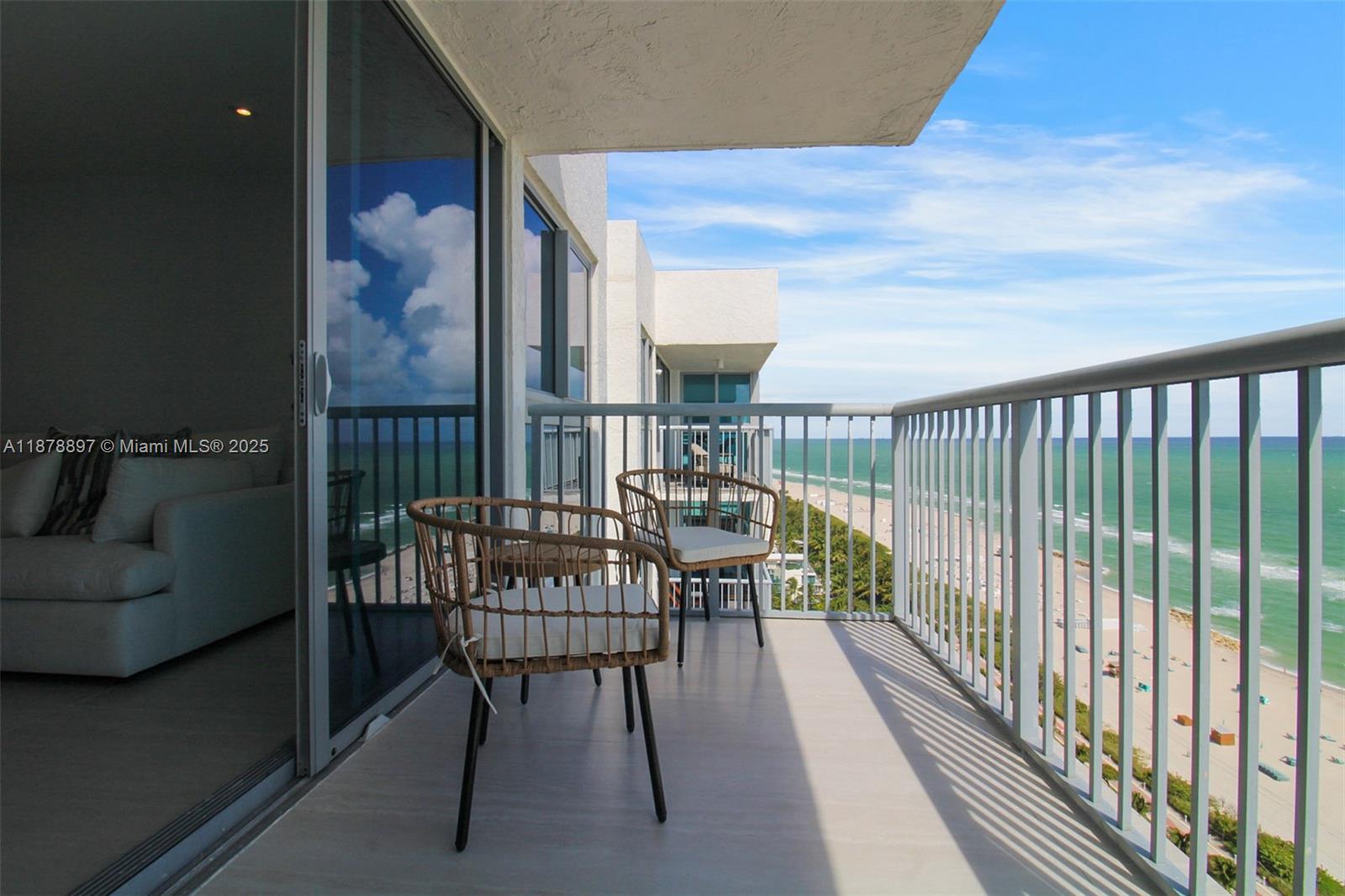 2655 Collins Avenue, Unit PH2512 Miami Beach, FL 33140 - Photo 13 of 21 a balcony with table and chairs