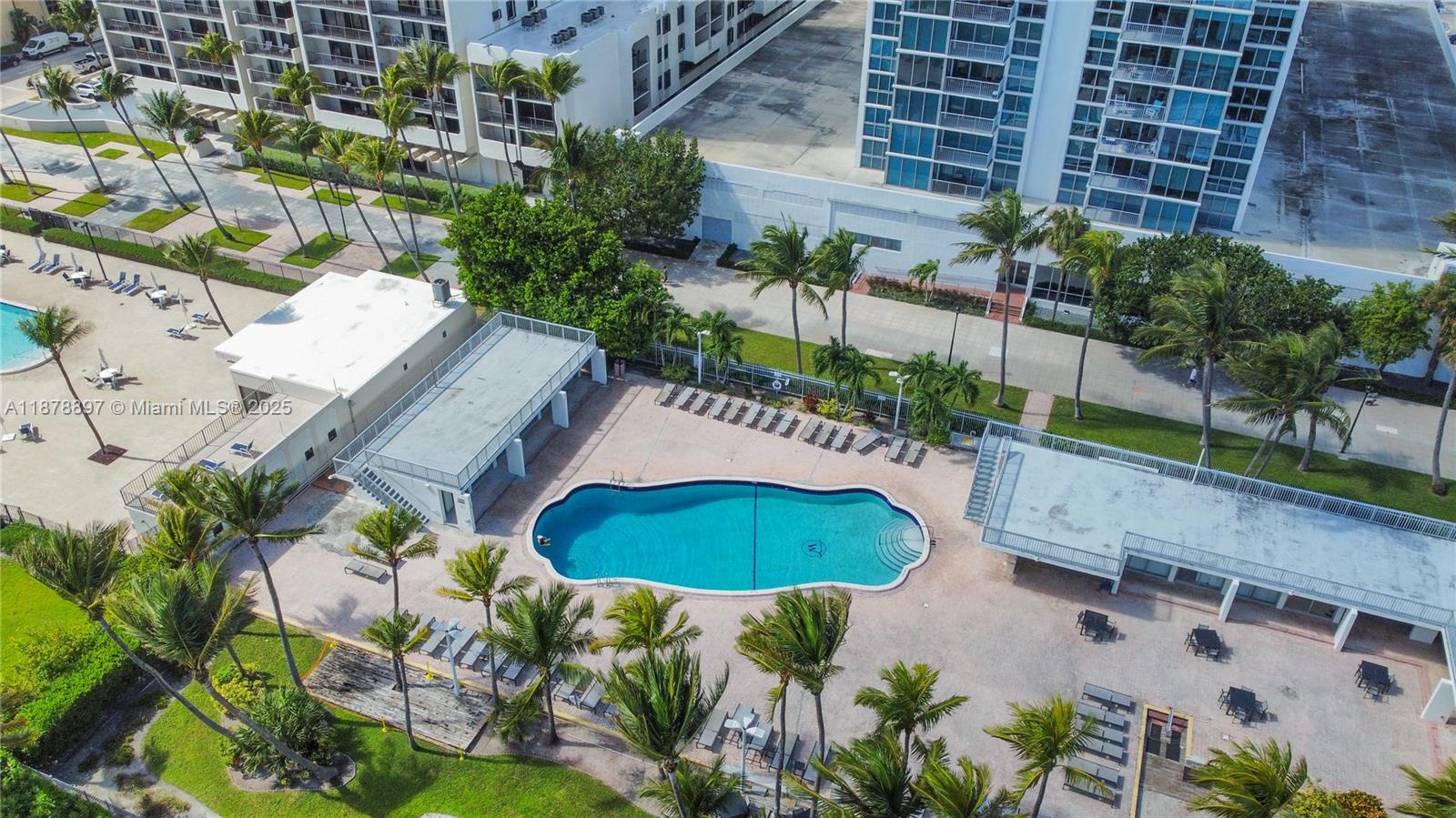 2655 Collins Avenue, Unit PH2512 Miami Beach, FL 33140 - Photo 18 of 21 a view of a backyard with plants and outdoor seating