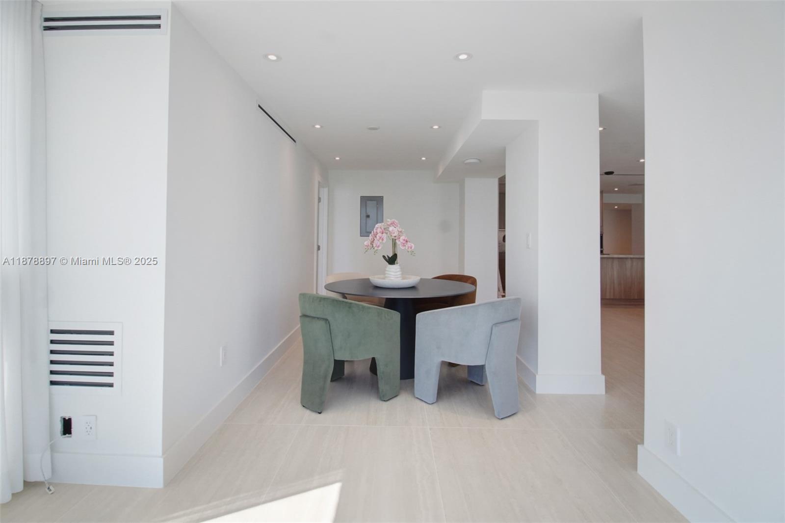 2655 Collins Avenue, Unit PH2512 Miami Beach, FL 33140 - Photo 8 of 21 a room with furniture and a potted plant