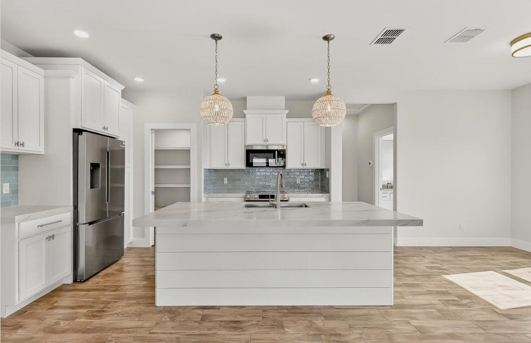 15206 Cruiser Street Corpus Christi, TX 78418 - Photo 5 of 10 a view of a kitchen with refrigerator and window