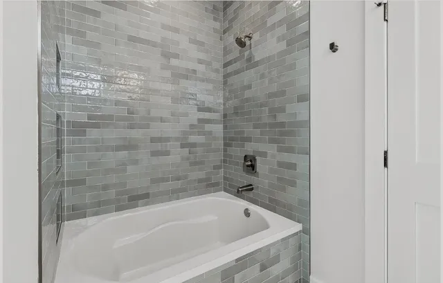 a bathroom with a shower and a glass door