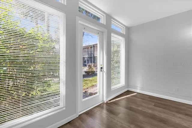 a view of a room with wooden floor and a window