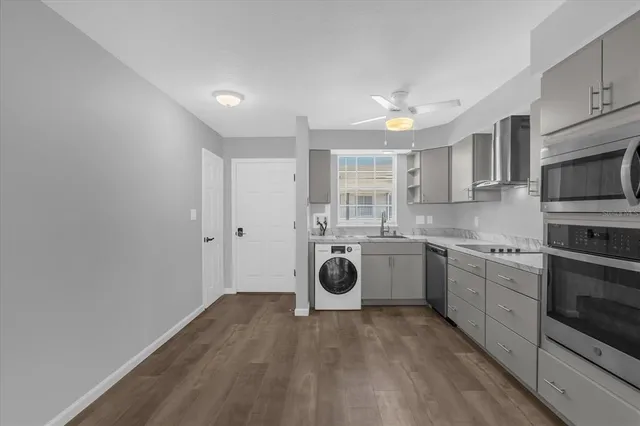 a kitchen with a refrigerator and microwave