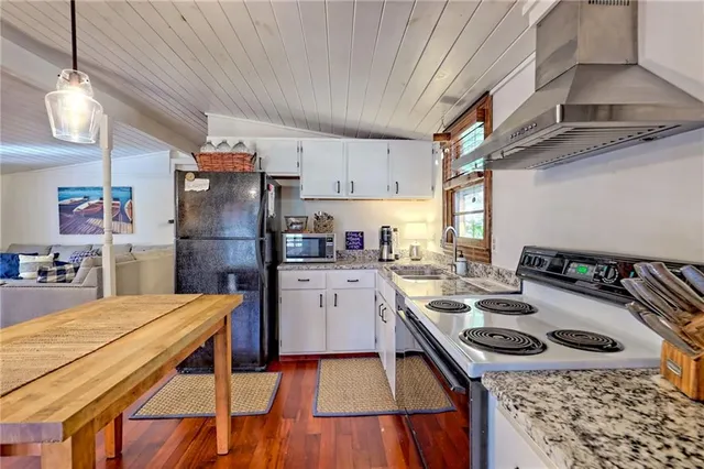 a view of a dining room with furniture wooden floor and chandelier