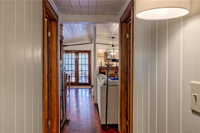 a view of a hallway with wooden floor and furniture
