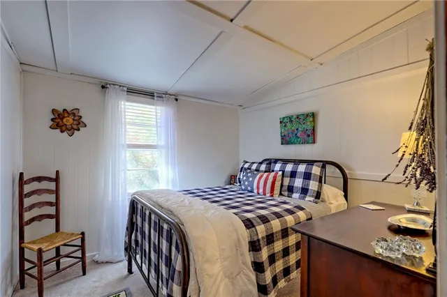a living room with furniture a wooden floor and a window