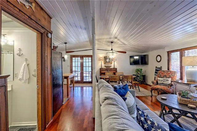 a living room with furniture a rug and a window