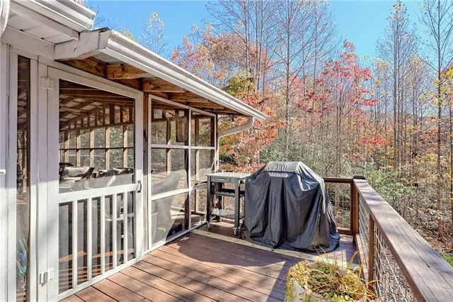 a view of a backyard with chairs and potted plants
