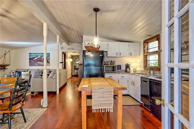 a kitchen with stainless steel appliances granite countertop a stove and cabinets