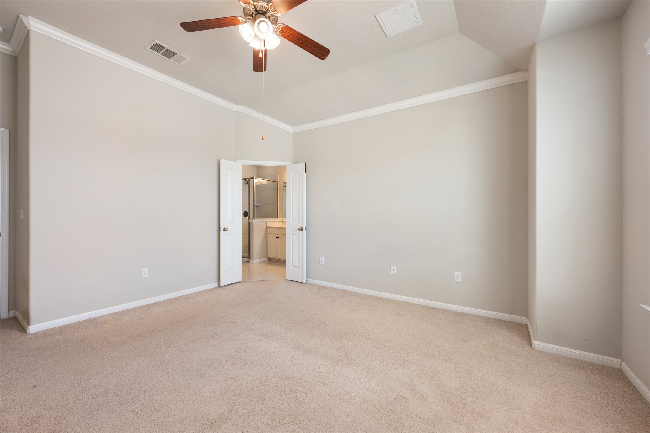 211 Parable Cove Pflugerville, TX 78660 - Photo 23 of 40 Bedroom featuring neutral carpeting, light-toned walls, and white crown molding