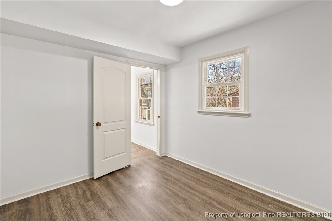 5434 Hampton Road Fayetteville, NC 28311 - Photo 11 of 45 an empty room with wooden floor and windows