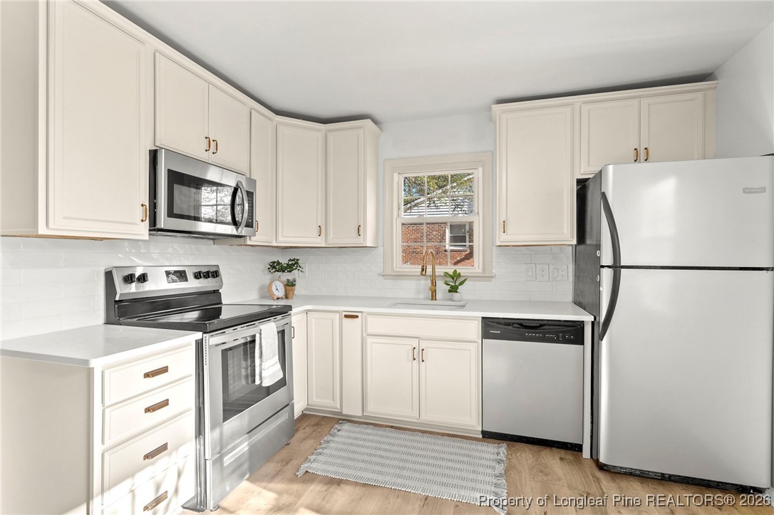 5434 Hampton Road Fayetteville, NC 28311 - Photo 17 of 45 a kitchen with stainless steel appliances granite countertop a refrigerator stove a sink and a microwave