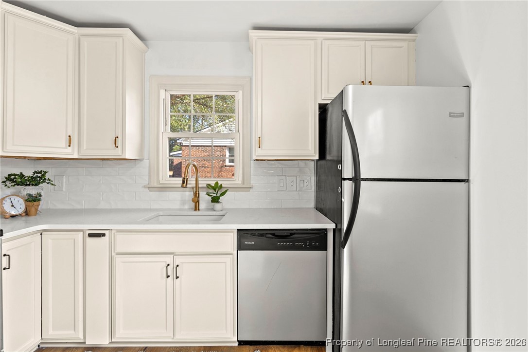 5434 Hampton Road Fayetteville, NC 28311 - Photo 18 of 45 a kitchen with stainless steel appliances a refrigerator sink and cabinets