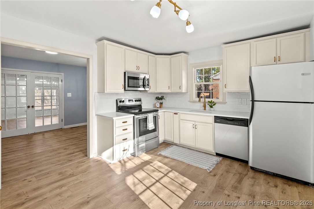 5434 Hampton Road Fayetteville, NC 28311 - Photo 2 of 45 a kitchen with white cabinets and white appliances