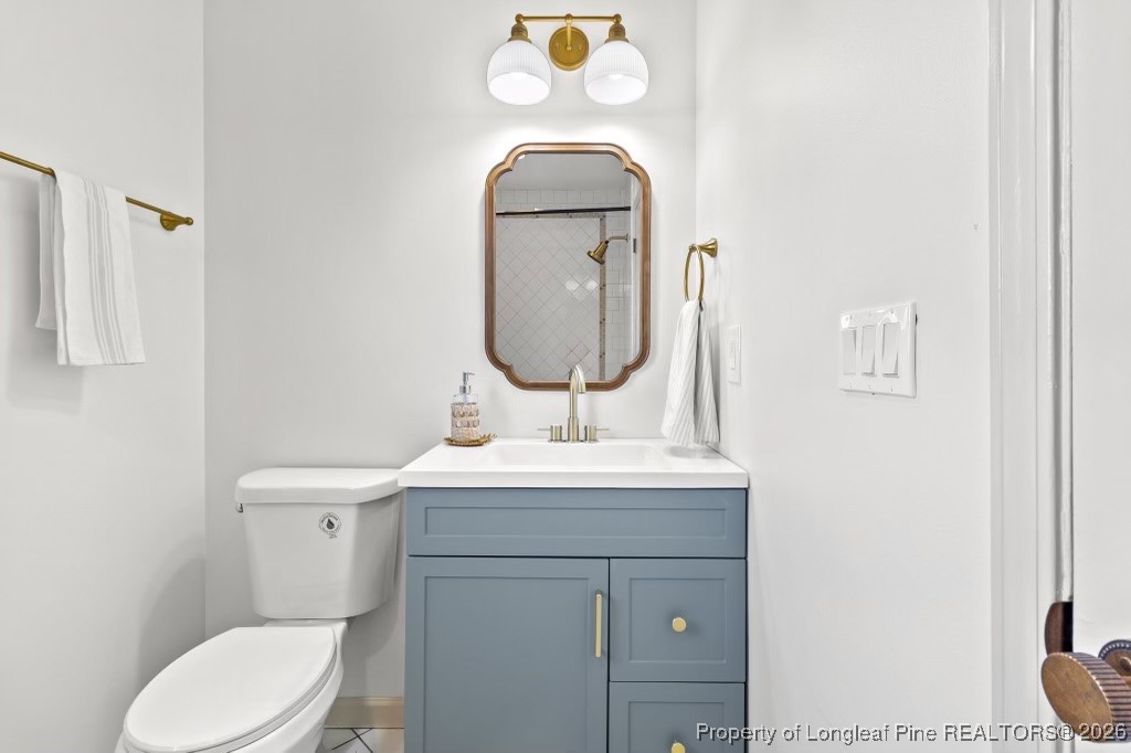 5434 Hampton Road Fayetteville, NC 28311 - Photo 28 of 45 a bathroom with a toilet a sink and a mirror