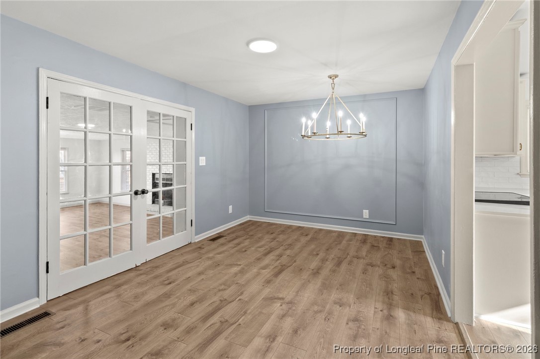 5434 Hampton Road Fayetteville, NC 28311 - Photo 3 of 45 wooden floor in an empty room with a window