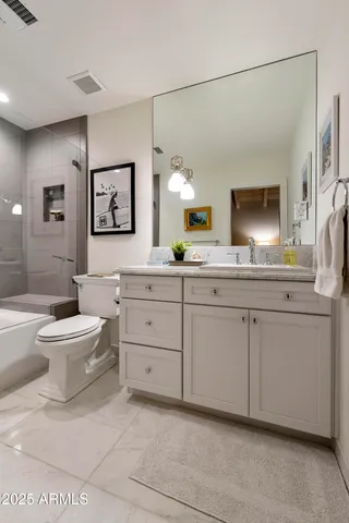 a spacious bathroom with a toilet sink and mirror
