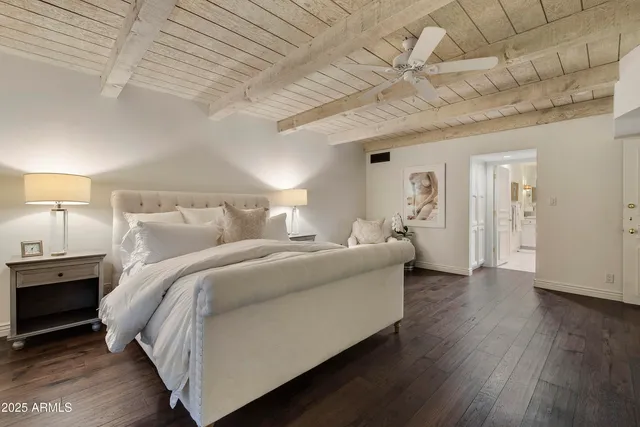 a bed room with a bed and a ceiling fan