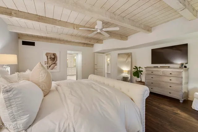 a bedroom with furniture and flat screen tv