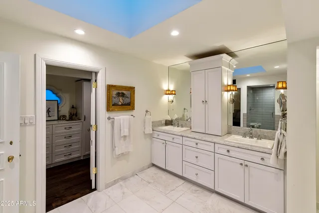 a spacious bathroom with a shower sink and mirror