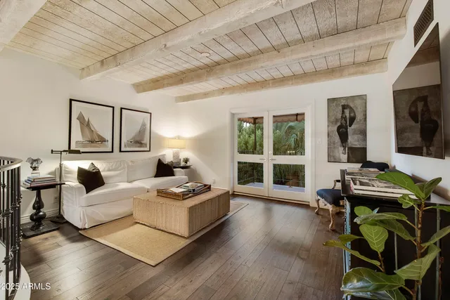 a living room with furniture a flat screen tv and a large window
