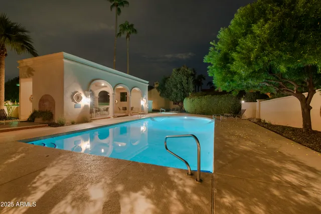 a tennis court with lots of trees in the background