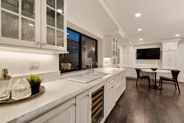 a kitchen with stainless steel appliances granite countertop a sink and cabinets