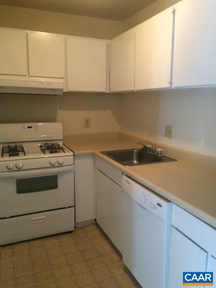 2691 Barracks Road, Unit 10 Charlottesville, VA 22901 - Photo 3 of 10 a kitchen with white cabinets and white appliances
