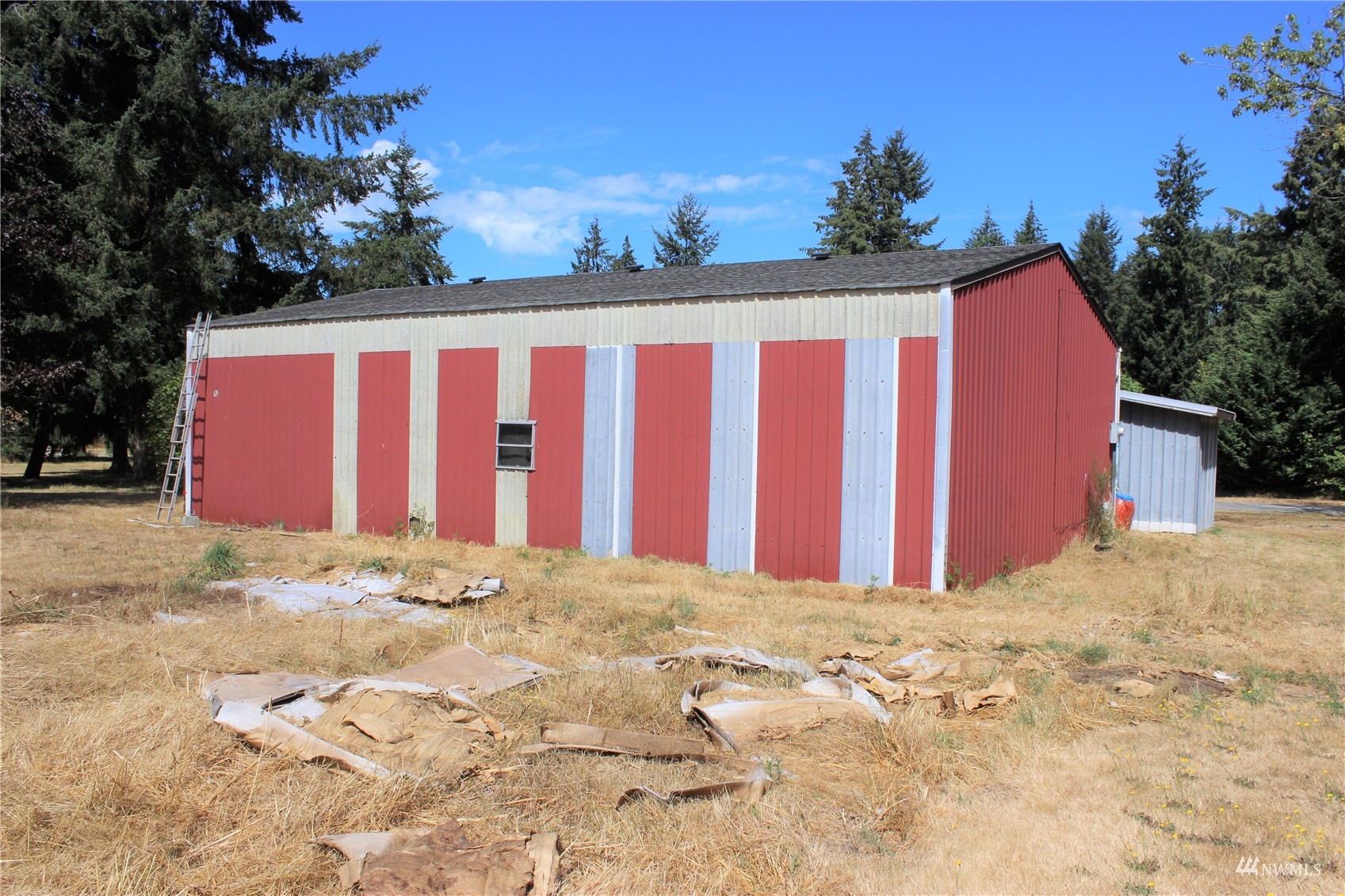17739 Pendleton Street Southwest Rochester, WA 98579 - Photo 5 of 26 a view of a blue house with a yard