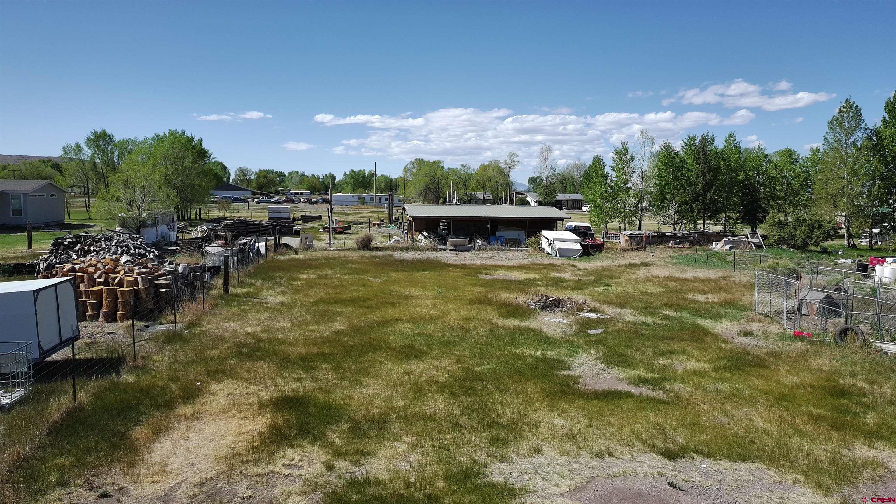 816 Main Street Manassa, CO 81141 - Photo 6 of 23 a view of a swimming pool with outdoor seating and a garden