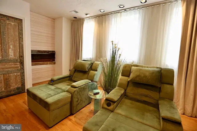 a living room with furniture and a floor to ceiling window