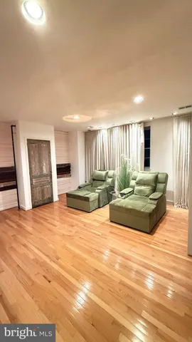 a room with a bed and a view of kitchen