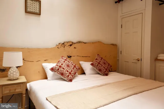 a bedroom with a bed and a night lamp