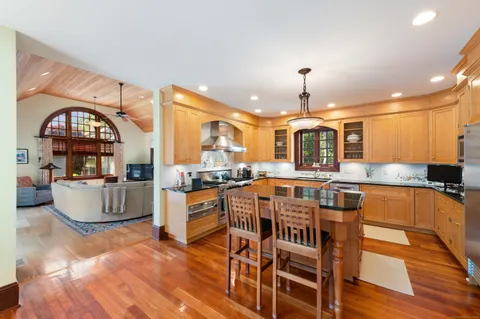 a large kitchen with a table and chairs