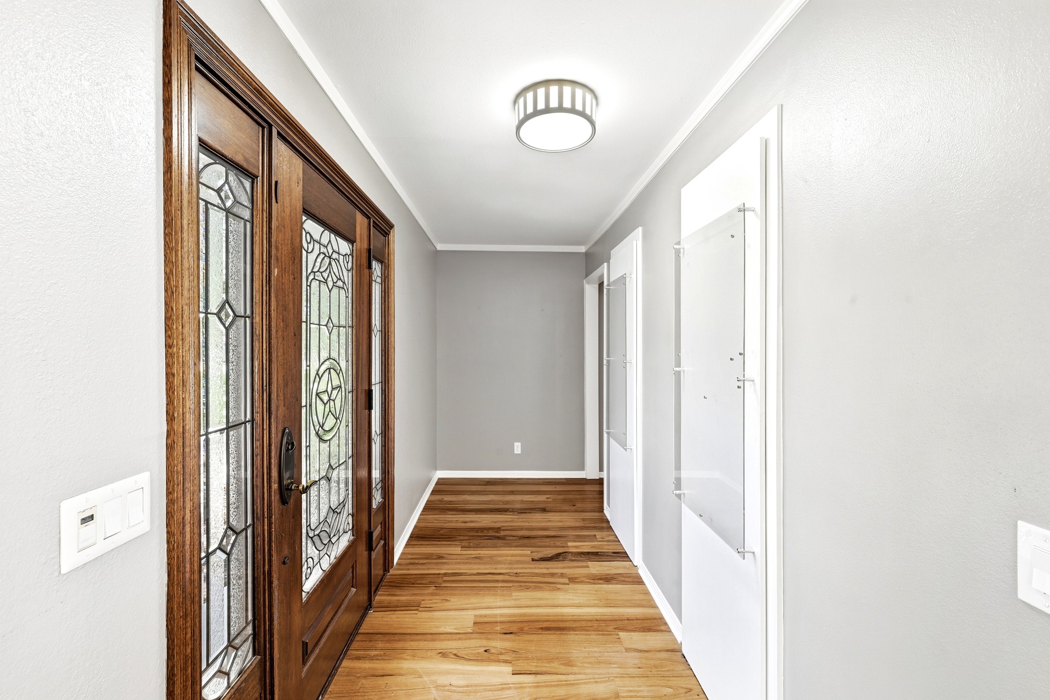 8608 Crest Ridge Circle Austin, TX 78750 - Photo 23 of 38 A welcoming entryway with gleaming wood flooring and an intricate leaded glass door with star design.