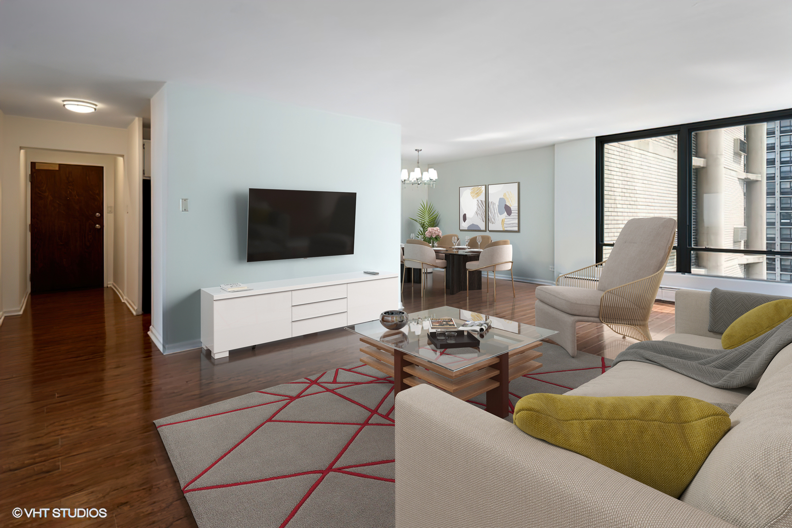 5740 North Sheridan Road, Unit 14C Chicago, IL 60660 - Photo 2 of 11 a living room with furniture and a flat screen tv
