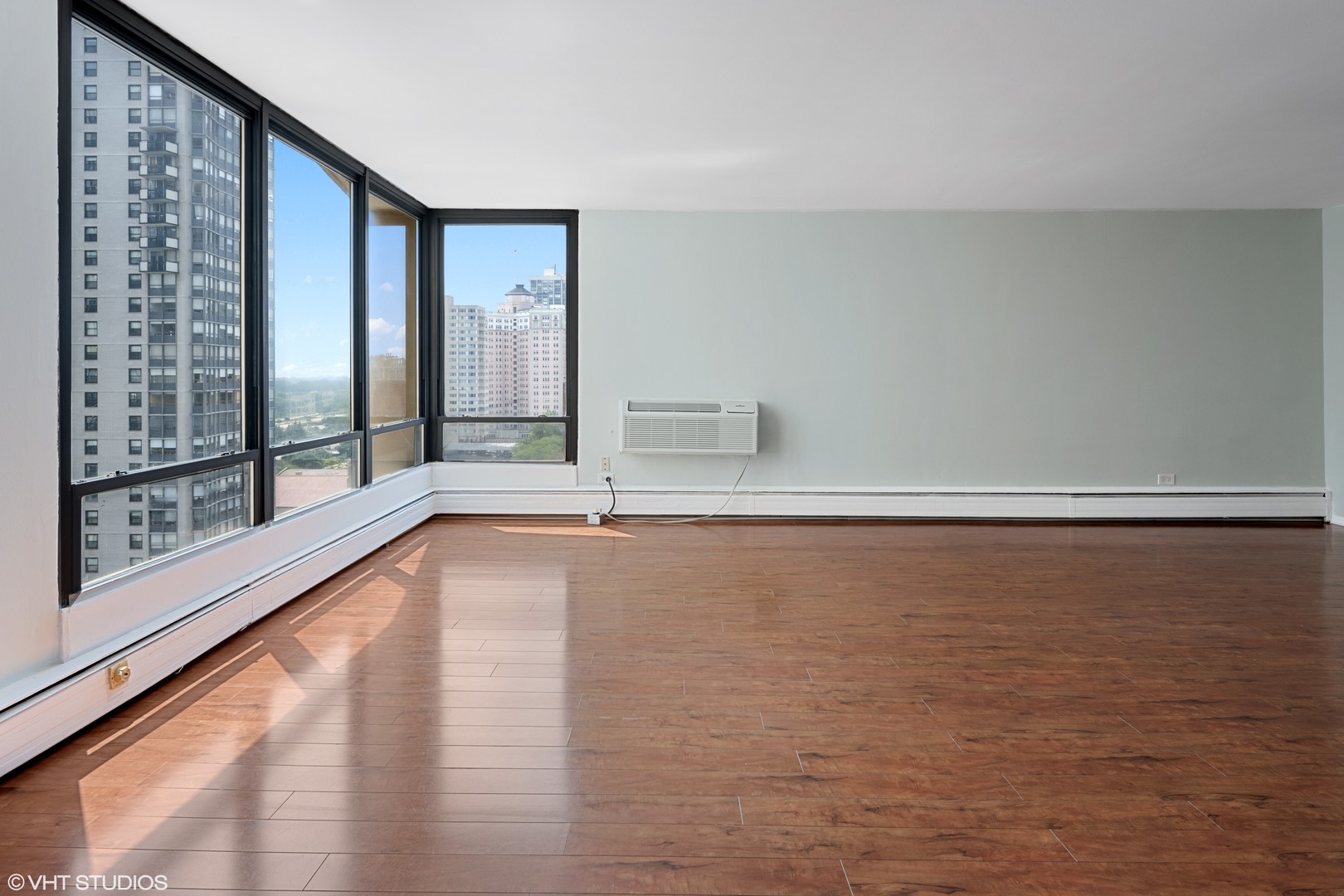 5740 North Sheridan Road, Unit 14C Chicago, IL 60660 - Photo 6 of 11 a view of room with window and wooden floor