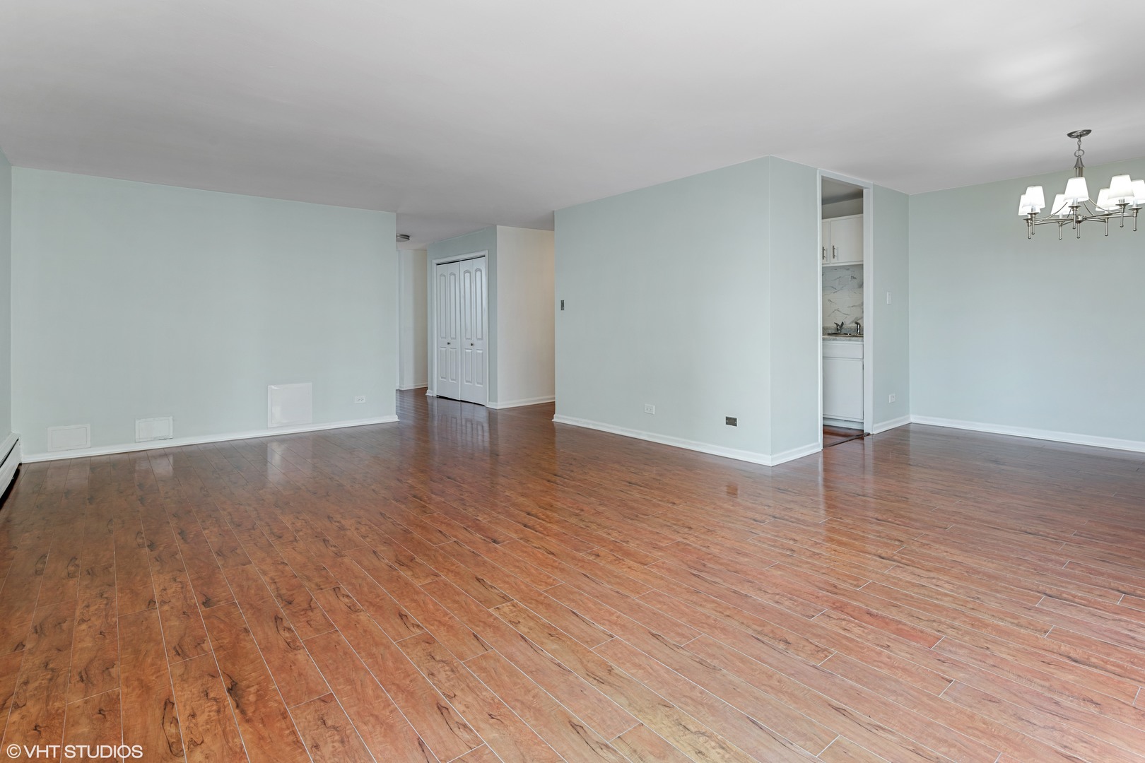 5740 North Sheridan Road, Unit 14C Chicago, IL 60660 - Photo 8 of 11 a view of an empty room with wooden floor