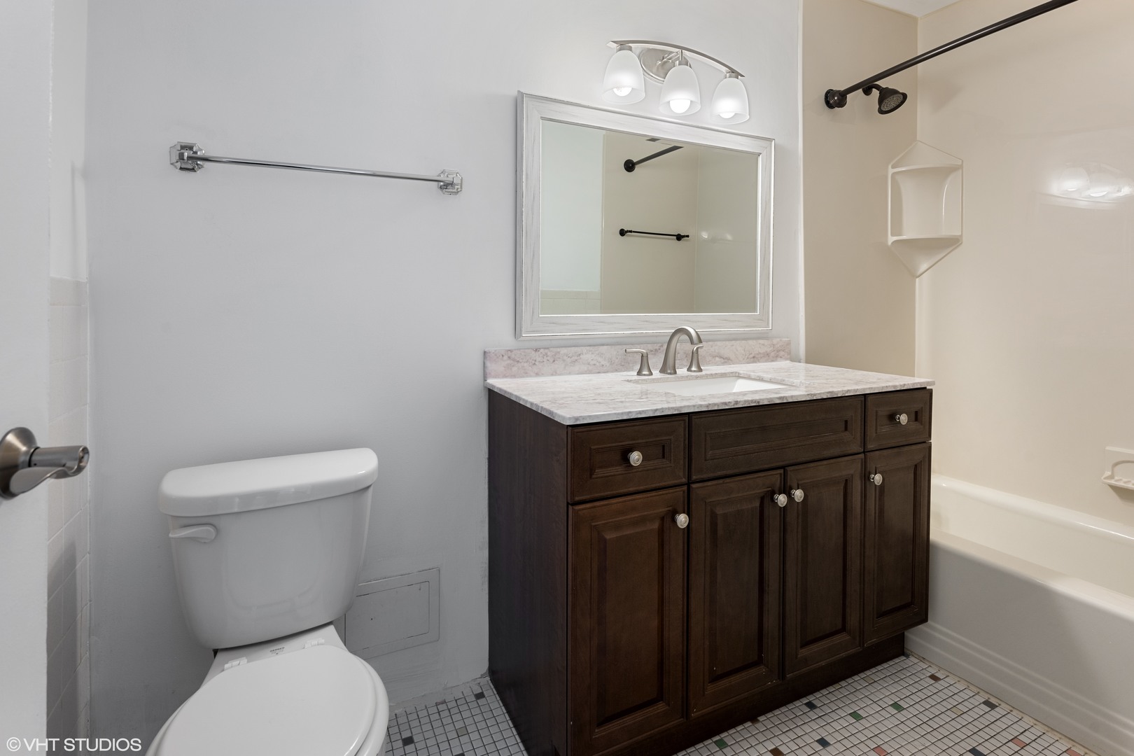 5740 North Sheridan Road, Unit 14C Chicago, IL 60660 - Photo 10 of 11 a bathroom with a granite countertop toilet sink and mirror