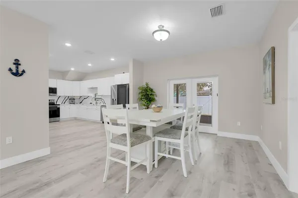 a kitchen with white cabinets and sink