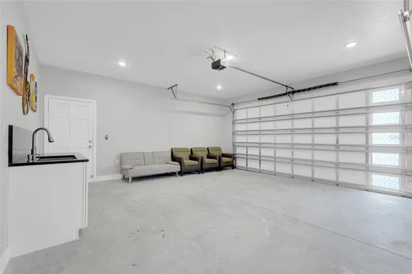 a view of kitchen with sink and refrigerator