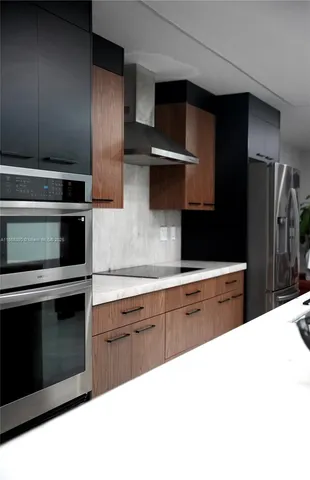 a stove top oven sitting inside of a kitchen