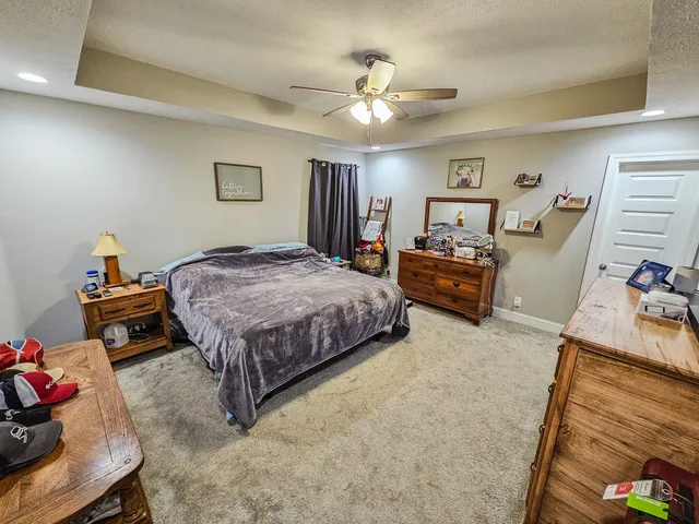 a bedroom with a bed and ceiling fan