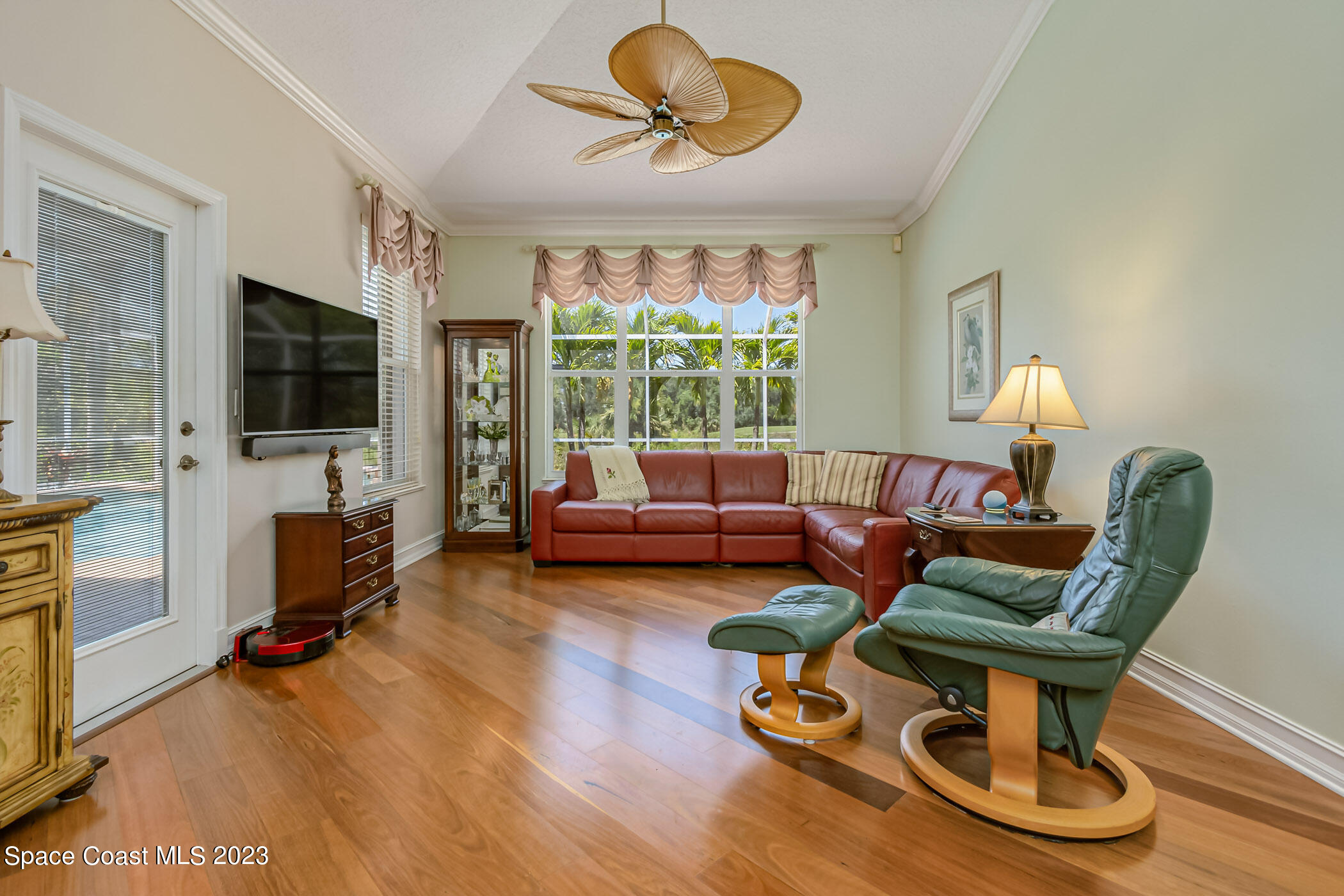 4481 Aberdeen Circle Rockledge, FL 32955 - Photo 16 of 70 a living room with furniture a flat screen tv and a floor to ceiling window