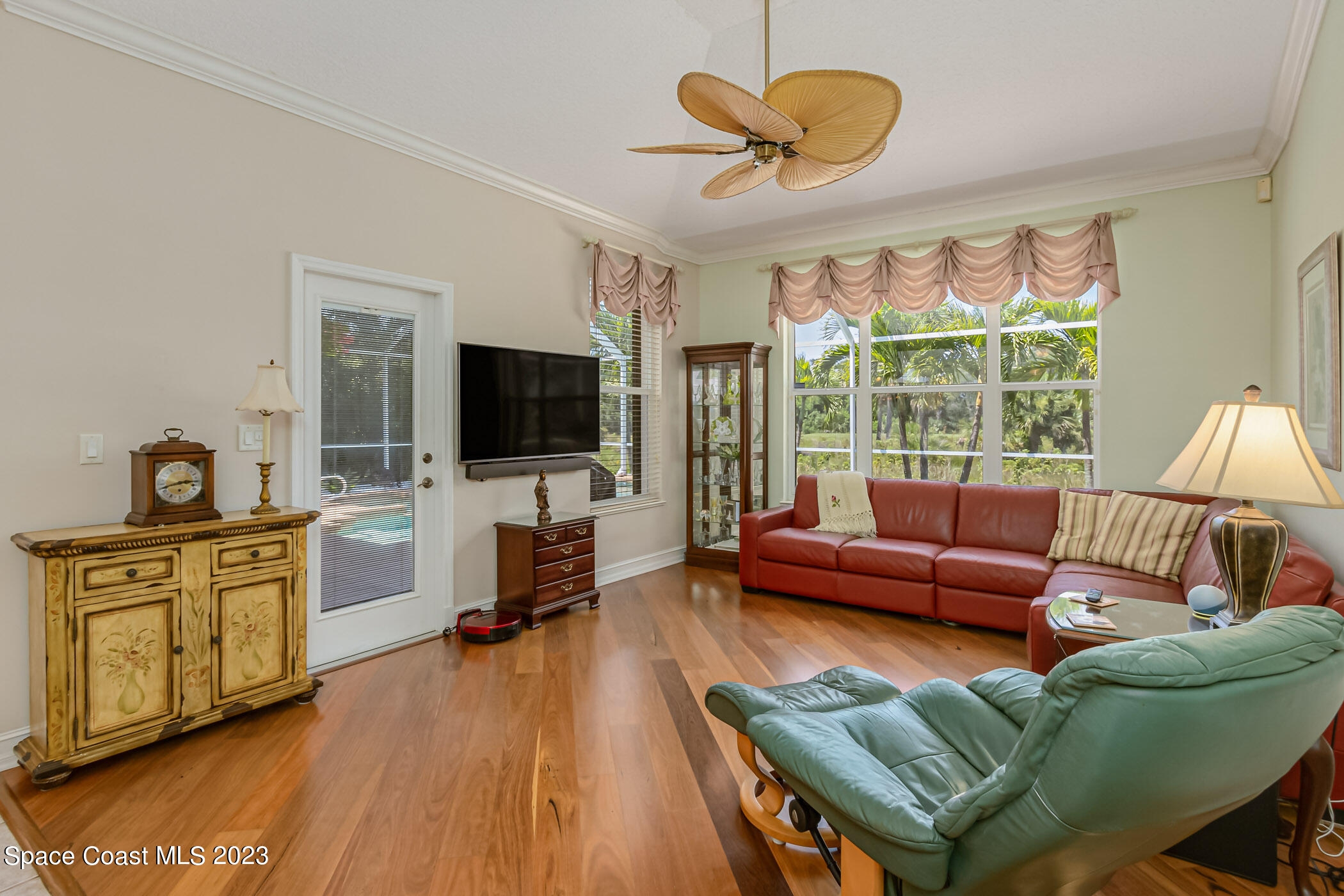 4481 Aberdeen Circle Rockledge, FL 32955 - Photo 17 of 70 a living room with furniture a flat screen tv and a floor to ceiling window