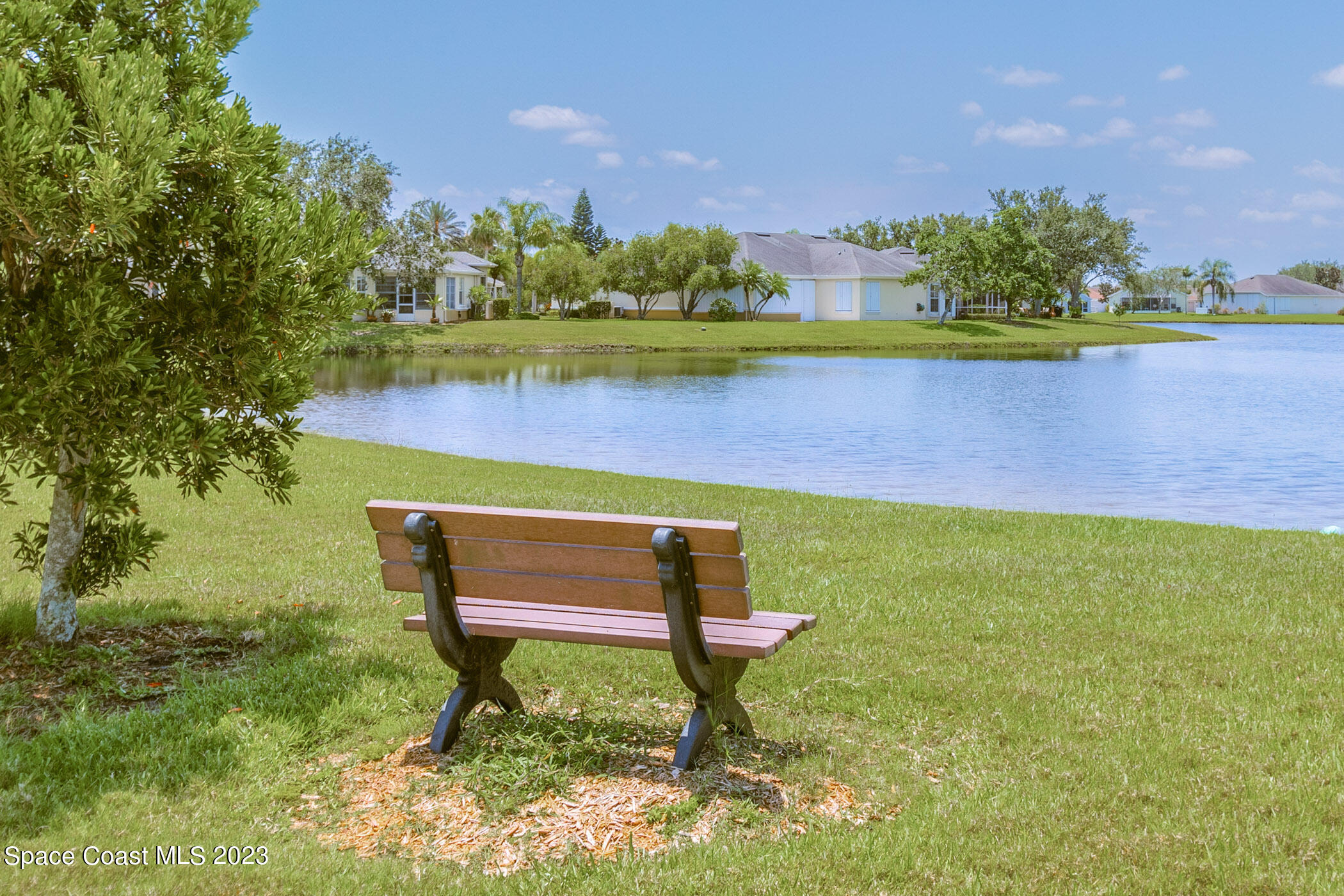 4481 Aberdeen Circle Rockledge, FL 32955 - Photo 38 of 70 a wooden bench sitting in the middle of a park