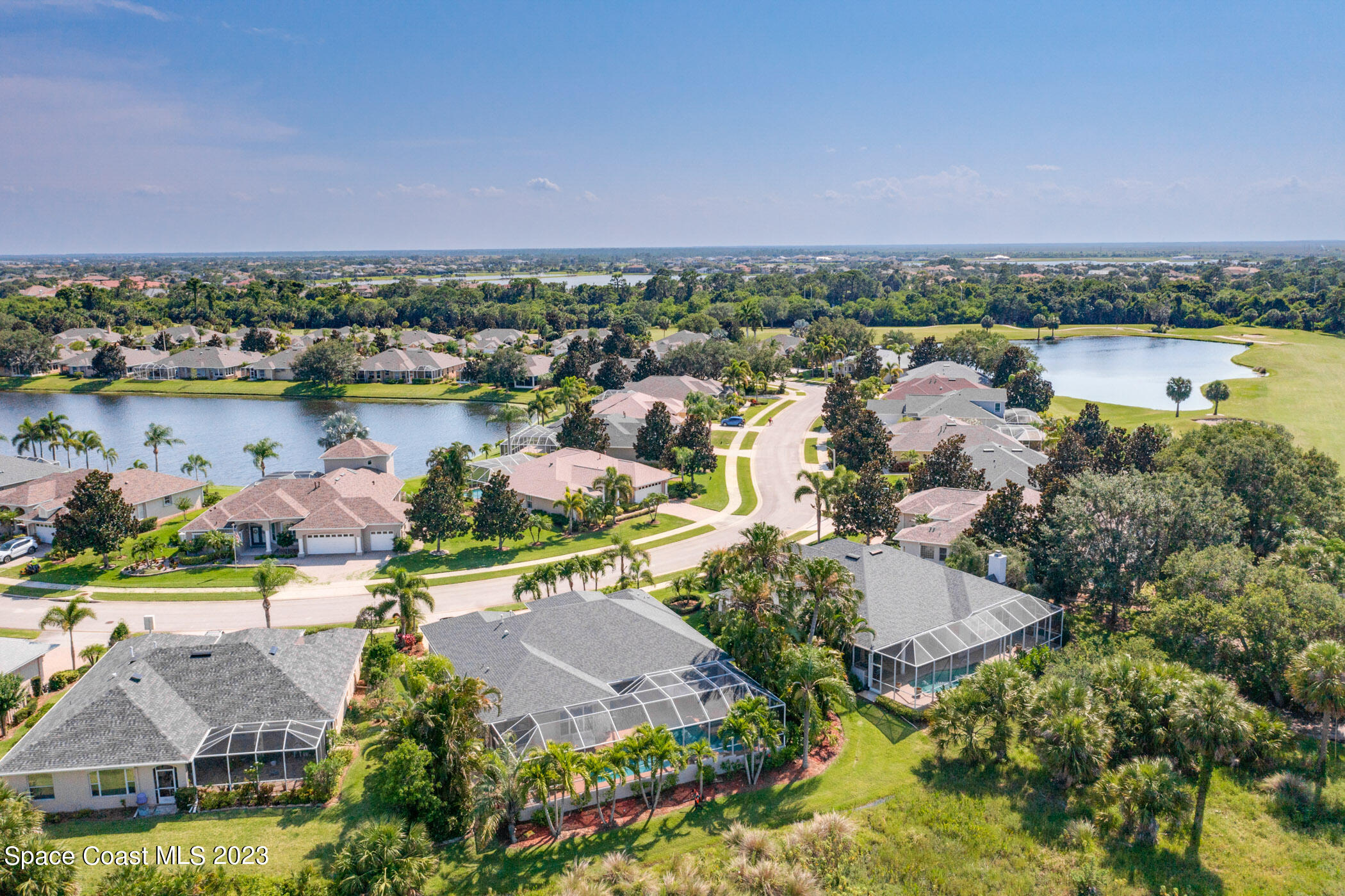 4481 Aberdeen Circle Rockledge, FL 32955 - Photo 54 of 70 an aerial view of a city with lots of residential buildings lake and ocean view